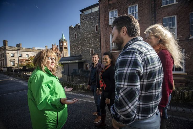 Tour group are guided around the walls in the area of the Tower Museum and Guild Hall in Derry - Londonderry